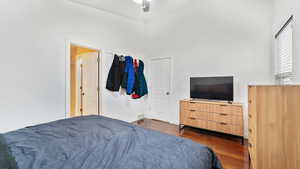 Bedroom featuring dark wood-type flooring and ceiling fan