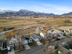 View of rural area with a mountainous background and nearby suburban area