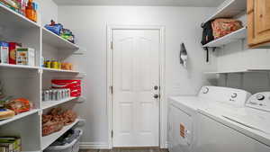 Laundry area featuring washing machine and dryer and dark wood finished floors