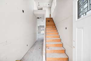 Staircase featuring a towering ceiling