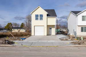Traditional-style house with roof with shingles and concrete driveway