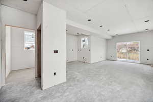 Unfurnished room with plenty of natural light and concrete flooring