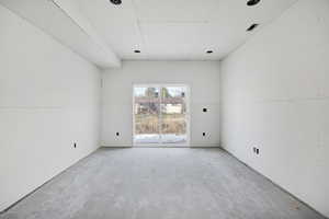 Spare room with unfinished concrete flooring
