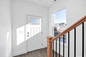 Entrance foyer with dark wood finished floors and stairway