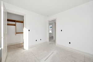 Unfurnished bedroom featuring baseboards and a closet
