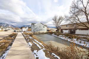 View of asphalt street featuring a residential view, sidewalks, and a mountain view