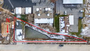 Aerial view of property and surrounding area featuring property parcel outlined