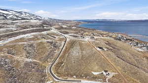 Aerial view of property and surrounding area with a water and mountain view