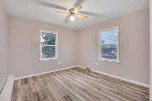 Spare room featuring light wood-style floors and a ceiling fan