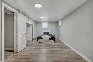 Bedroom featuring light wood-style floors and baseboards