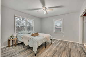 Bedroom with light wood-type flooring and a ceiling fan