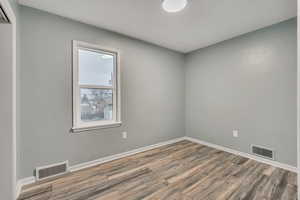 Spare room with wood finished floors and baseboards