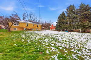 Snow covered back of property with roof mounted solar panels