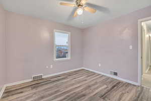 Unfurnished room featuring light wood finished floors and ceiling fan