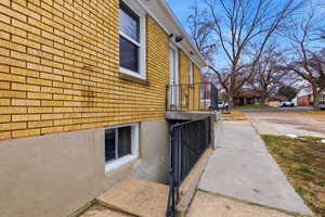View of side of home with brick siding and a residential view