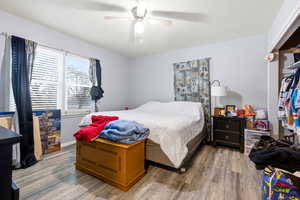 Bedroom with wood finished floors and a ceiling fan