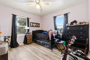 Bedroom featuring light wood-style flooring and a ceiling fan