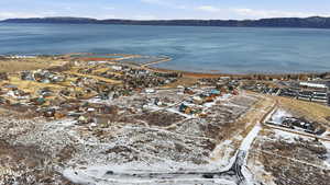 Aerial overview of property's location with a water and mountain view and nearby suburban area