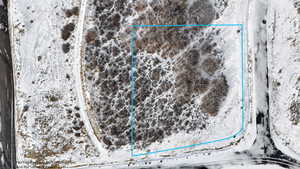 Aerial view of sparsely populated area with property parcel outlined and a desert landscape