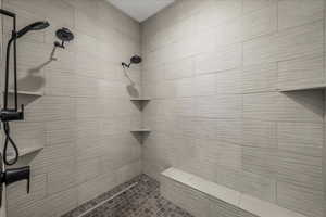Full bath featuring tiled shower