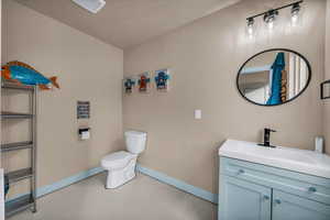 Bathroom featuring vanity and concrete floors