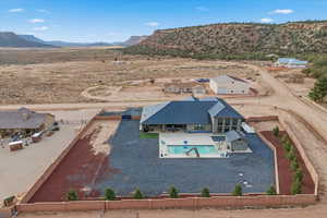 View from above of property with a pool and a mountain backdrop