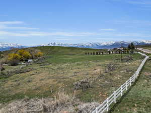 View of mountain backdrop with rural landscape and agricultural land