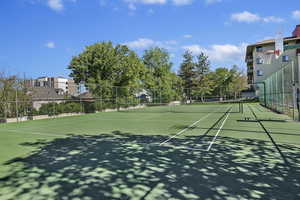 View of tennis court with community basketball court