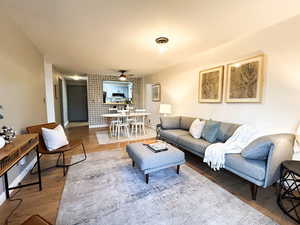Living area with wood finished floors and baseboards