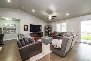 Living room with recessed lighting, lofted ceiling, wood-type flooring, and ceiling fan