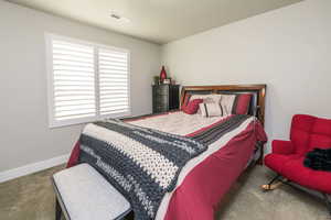 Bedroom featuring carpet floors and baseboards