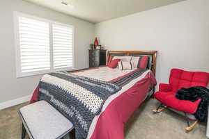 Bedroom featuring carpet floors and baseboards