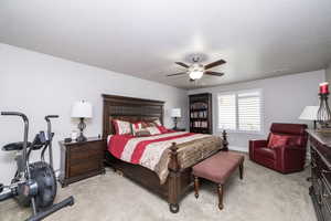 Bedroom featuring light carpet and ceiling fan