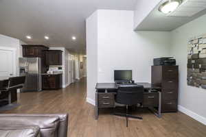 Office featuring dark wood-style floors, recessed lighting, and a textured ceiling