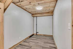 Spare room featuring wooden ceiling and light wood finished floors