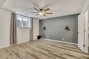 Empty room featuring a ceiling fan and light wood-type flooring