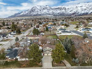 Aerial view of property's location featuring nearby suburban area and a mountainous background
