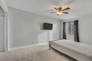 Bedroom featuring carpet and a ceiling fan