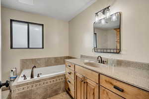 Full bath with a garden tub and vanity