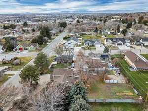 Aerial view of property's location with nearby suburban area and a mountainous background