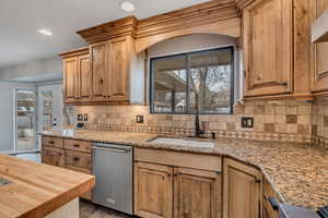 Kitchen featuring butcher block counters, dishwasher, recessed lighting, plenty of natural light, and backsplash