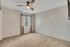 Spare room with carpet floors and ceiling fan