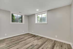 Unfurnished room with light wood finished floors and baseboards