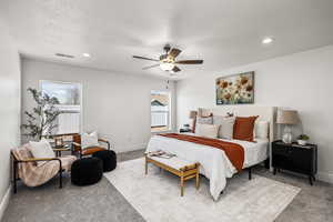 Bedroom featuring carpet floors, recessed lighting, a ceiling fan, and a textured ceiling