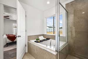 Ensuite bathroom with a garden tub, a stall shower, healthy amount of natural light, and recessed lighting