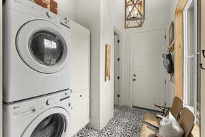 Laundry area with stacked washer / dryer and cabinet space