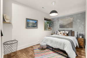 Bedroom featuring baseboards and wood finished floors