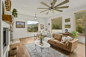Living area with light wood-style floors and ceiling fan