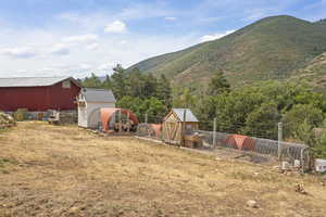View of yard with an outbuilding, exterior structure, and a mountain view