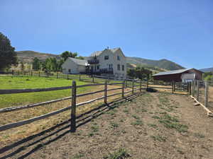 View of yard featuring an outbuilding, a view of rural / pastoral area, and a mountain view